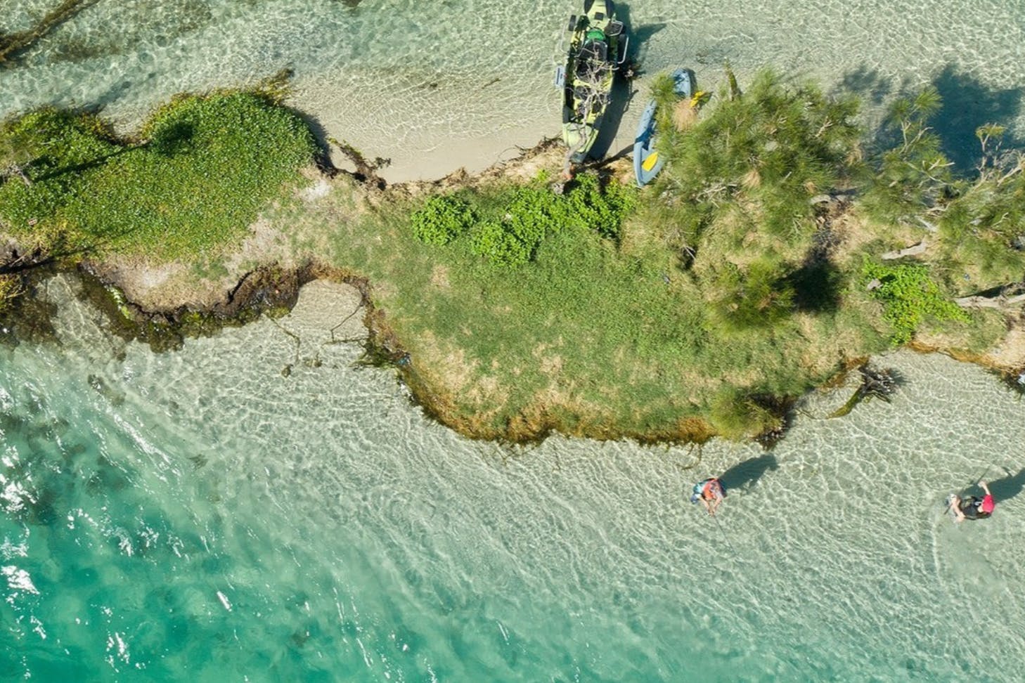 A bird's eye view of Lake Macquarie, where two men are fishing in shallow waters